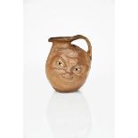 A large Martin Brothers stoneware face jug, modelled in low relief with a smiling face, the