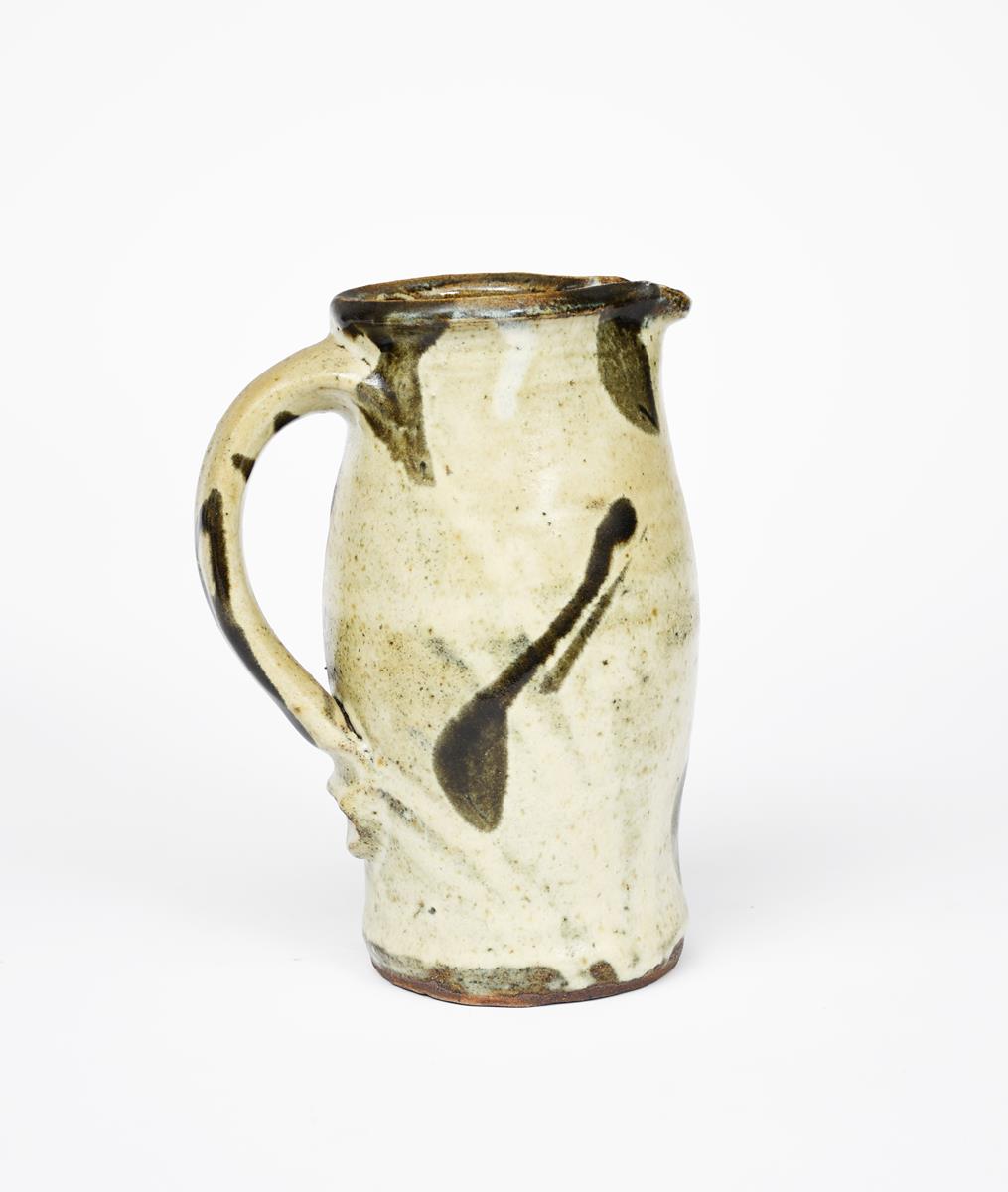 Shoji Hamada (1894-1978) a stoneware jug, bellied form, covered with a speckled sage green glaze