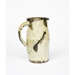 Shoji Hamada (1894-1978) a stoneware jug, bellied form, covered with a speckled sage green glaze