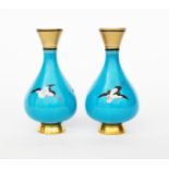 A pair of Mintons Cloisonne vases in the manner of Dr Christopher Dresser, footed form with