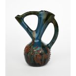 A Sunflower Pottery ewer by Sir Edmund Elton, ovoid with angled handle and tube neck, applied with