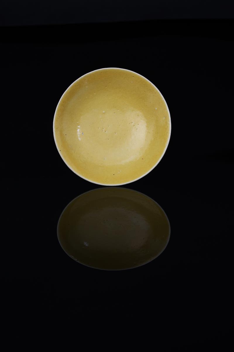 Dame Lucie Rie DBE 1902-1995) a stoneware shallow bowl or dish, covered in a bright yellow glaze