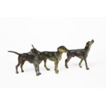 Three large cold-painted bronze models of hounds, each modelled standing, unsigned, 15cm. high (