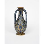 A Martin Brothers stoneware twin-vase by Robert Wallace Martin, incised with scrolling foliage on
