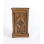 An Aesthetic Movement bedside cabinet, rectangular section, the hinged, panelled door with carved