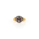 A ruby and diamond ring, designed as an owl's face, set with rose-cut diamonds and circular-cut