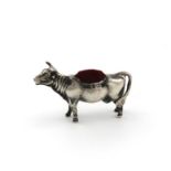 An Edwardian silver novelty cow pincushion by Levi & Salaman, Birmingham 1906, modelled in a