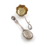 An American parcel-gilt silver tea strainer, by George Shiebler and Co., New York, deep leaf form,