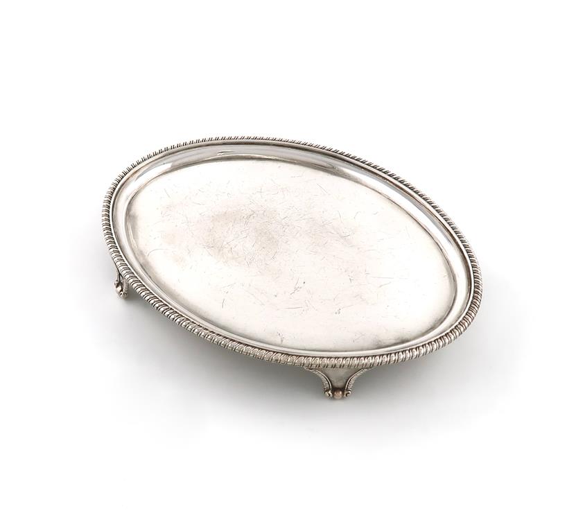 A George silver waiter, by Timothy Renou, London 1803, oval form, gadroon border, on four bracket
