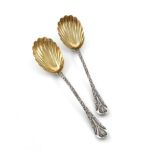 A pair of Victorian silver Newton pattern fruit serving spoons, by George Adams, London 1874, gilded