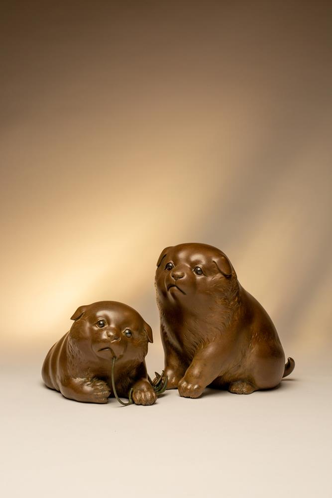 A pair of Japanese models of puppies Meiji or Taisho, 19th or 20th Century The two charming dogs