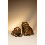 A pair of Japanese models of puppies Meiji or Taisho, 19th or 20th Century The two charming dogs