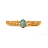 An early 20th century Egyptian revival winged sun brooch, swivel-set with a faience scarab, within