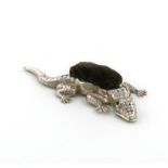 A novelty silver lizard pin cushion, by Crisford & Norris Ltd., Birmingham 1910, length 10.8cm.