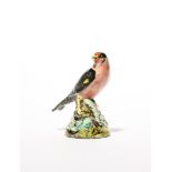 A pearlware bird whistle early 19th century, modelled as a goldfinch seated on a low stump applied