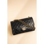 Chanel, a quilted black medium double flap bag, the black leather with gold tone hardware, with