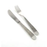 By Gerald Benney, a modern silver table knife and fork, London 1969 tapering textured handles, the