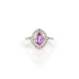 A pink sapphire and diamond ring, collet-set with an oval pink sapphire weighing 0.90 carats, within