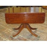 A good quality Regency mahogany Pembroke table, raised on a turned pillar and swept quadruped
