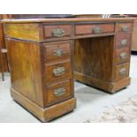 A Victorian walnut pedestal writing desk fitted with nine drawers, original brass plate handles,