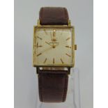 Vintage gent's gold plated Movado dress watch with square champagne dial and gilt baton markers,