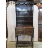 A good quality old English style oak cottage dresser, the recessed open plate rack with three
