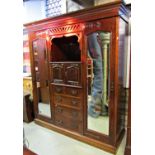 A good quality Edwardian mahogany triple compactum wardrobe with Arts and Crafts influence/