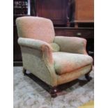 A Victorian drawing room chair, with shaped outline repeating scrolling floral patterned upholstery,