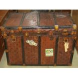 A vintage fibre and reinforced cabin trunk with metal fittings, stitched leather side carrying