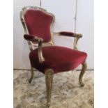 An antique gilt open armchair with upholstered seat and shield shaped panelled back within a moulded