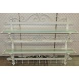 A decorative painted steel wall mounted flight of open hall wall shelves with strapwork frame,