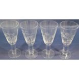 Four large stemmed wines, trumpet shaped bowls with etched detail showing daffodils, snowdrop,