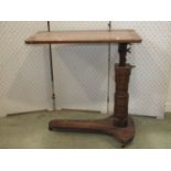A Victorian oak invalid table, ratchet height adjustable, with cast brass and iron fittings,