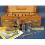 Vintage leather dressing/vanity case with canvas cover fitted with two silver brushes and four