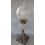 Edwardian cast iron and pressed glass oil lamp, 55cm high including flue