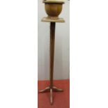 An oak jardiniere stand, the column of octagonal form supporting a square cut plinth and turned