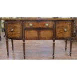 A Georgian mahogany sideboard with shaped outline, enclosed by three drawers and a central lower