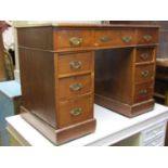 A Victorian walnut kneehole three sectional twin pedestal desk with inset faux leather panelled