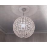 A pair of globular light shades with glass bead fittings, 35 cm in height approximately