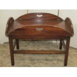 A mahogany butlers tray in the Georgian style with brass hinged and pierced rounded drop flaps and