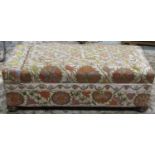 An early 20th century box ottoman of rectangular form with hinged lid, crewel work floral