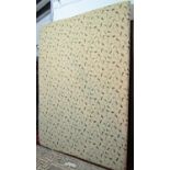 A large upholstered bed head board of rectangular form with repeating scrolling foliate patterned