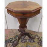 A Victorian walnut and figured walnut trumpet shaped sewing box raised on a carved tripod base