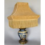 A converted far Eastern blue and white vase with electric light fitting and a pagoda shaped shade,