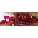 A collection of Victorian and later cranberry and cranberry style glass wares to include drinking