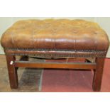 A Georgian style stool with deep button tan coloured leather top, brass breaded borders and raised