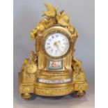 French ormolu figural mantel clock mounted by a fallen torch and turtle doves, flanked by musical