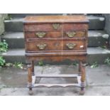 A small yew wood veneered sewing chest, the rising lid revealing a segmented interior over two