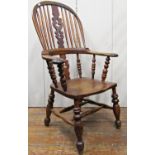 A 19th century Windsor elbow chair in mixed timber with pierced splat on turned supports and rails