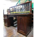 Mid-19th century mahogany pedestal sideboard, the central arch enclosing a frieze drawer, the